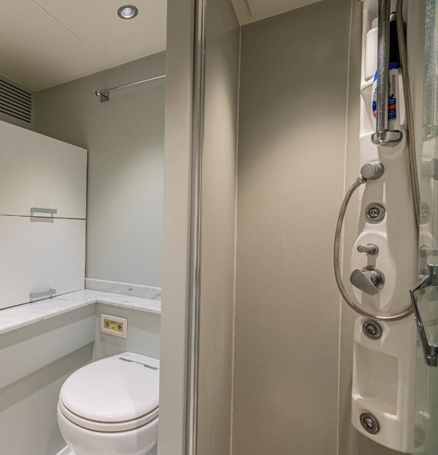 a bathroom with a toilet and shower aboard EDESIA Yacht for Charter