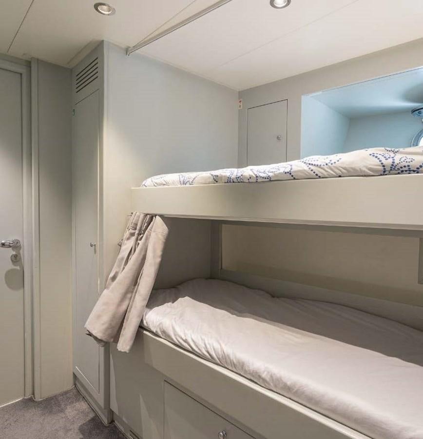 a bed with a white sheet aboard EDESIA Yacht for Charter