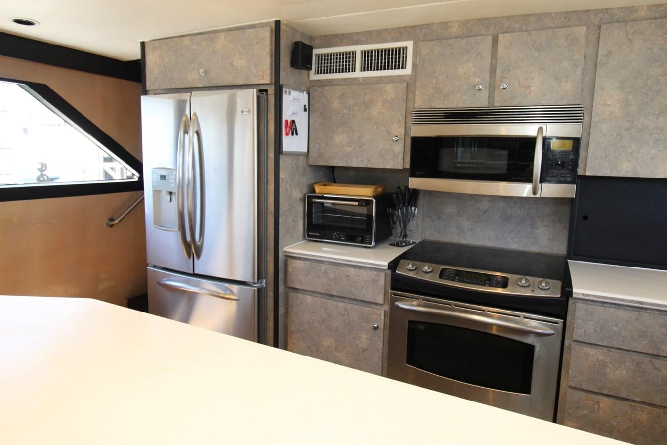 a kitchen with stainless steel appliances aboard PANACHE Yacht for Sale