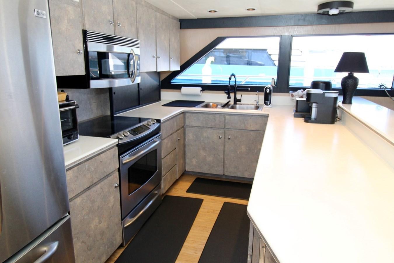 a large kitchen with a large screen aboard PANACHE Yacht for Sale
