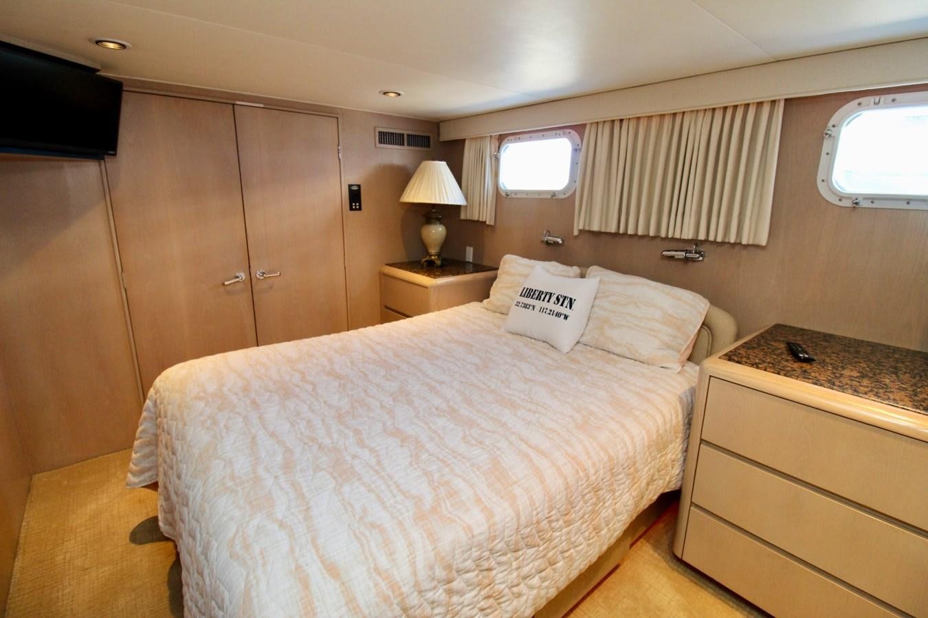 a bedroom with a bed and a desk aboard PANACHE Yacht for Sale