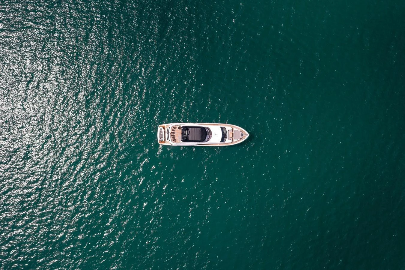A sleek yacht cruises gracefully on calm, emerald waters. aboard SUNSEEKER Yacht for Sale