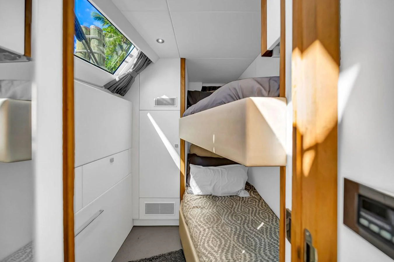 The cozy cabin features bunk beds and a skylight, providing a comfortable and well-lit sleeping area. aboard SUNSEEKER Yacht for Sale