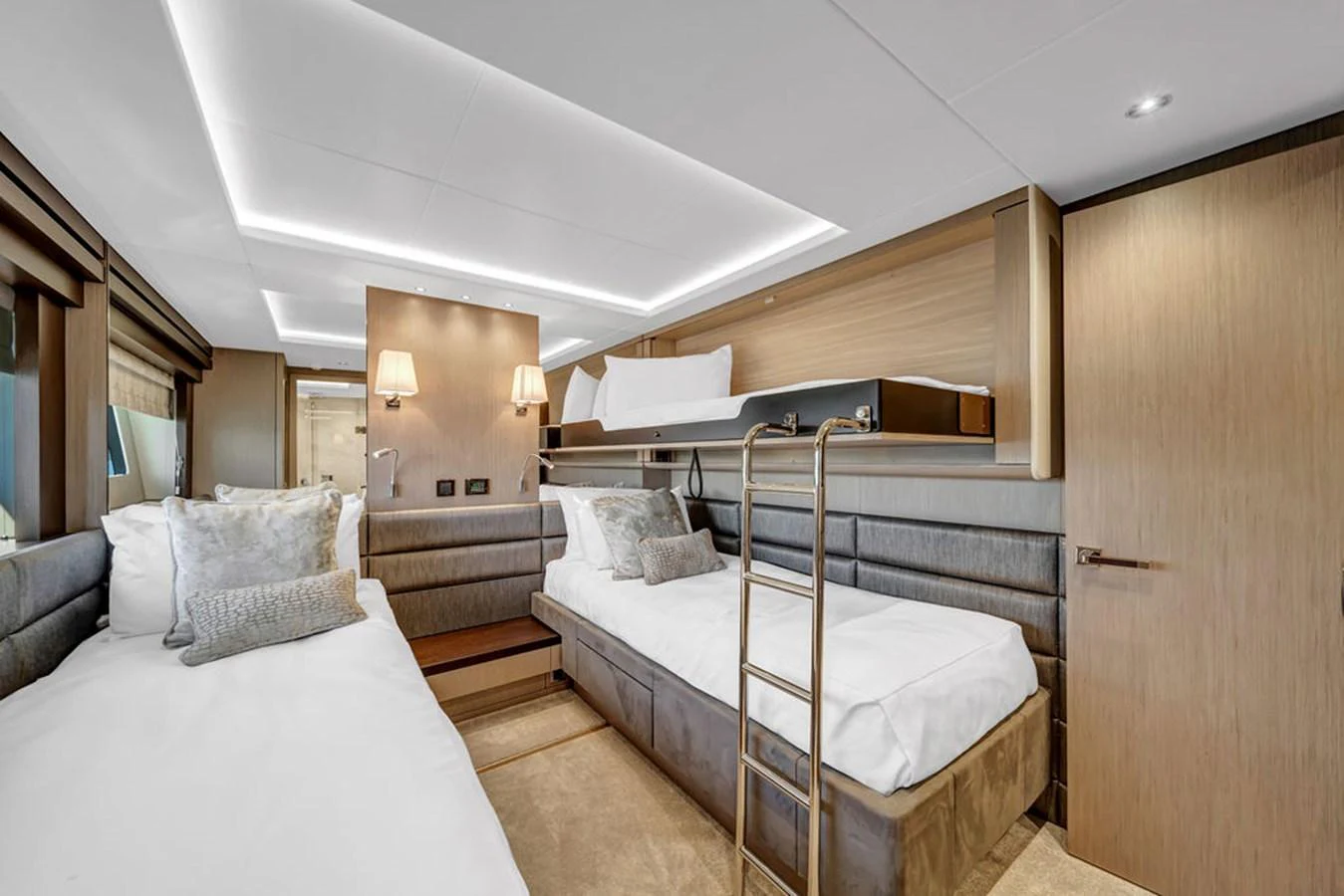 The guest cabin features twin beds with a modern, elegant design and ample lighting. aboard SUNSEEKER Yacht for Sale
