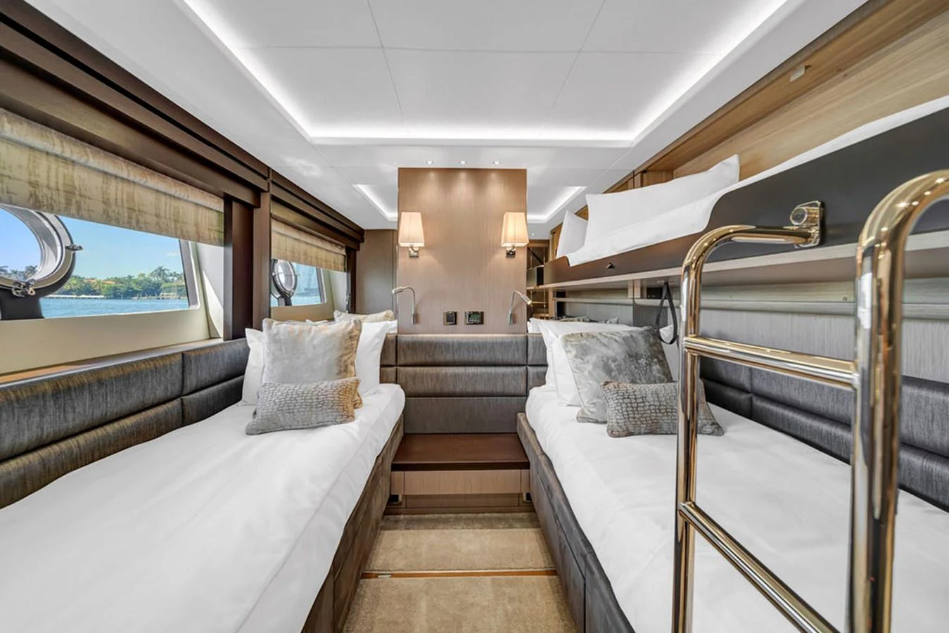 The guest stateroom features twin beds with elegant bedding and ample natural light from the windows. aboard SUNSEEKER Yacht for Sale