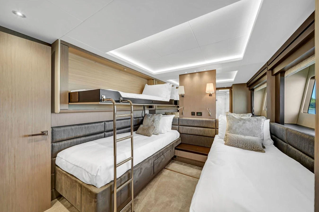 The guest stateroom features twin beds and a bunk bed, offering a comfortable and stylish sleeping arrangement. aboard SUNSEEKER Yacht for Sale