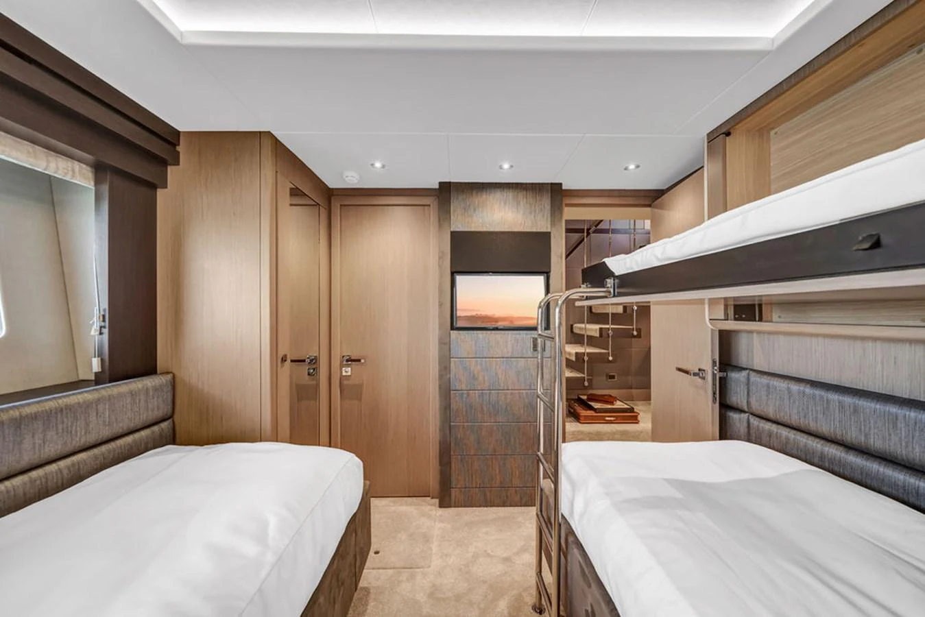 The image showcases a well-appointed guest cabin with twin beds and modern decor. aboard SUNSEEKER Yacht for Sale