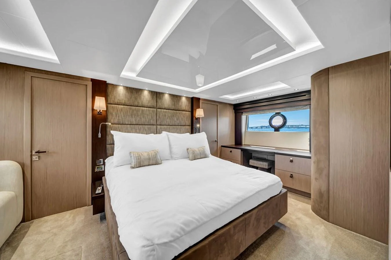 The master stateroom features a luxurious bed with elegant lighting and a scenic view through the window. aboard SUNSEEKER Yacht for Sale