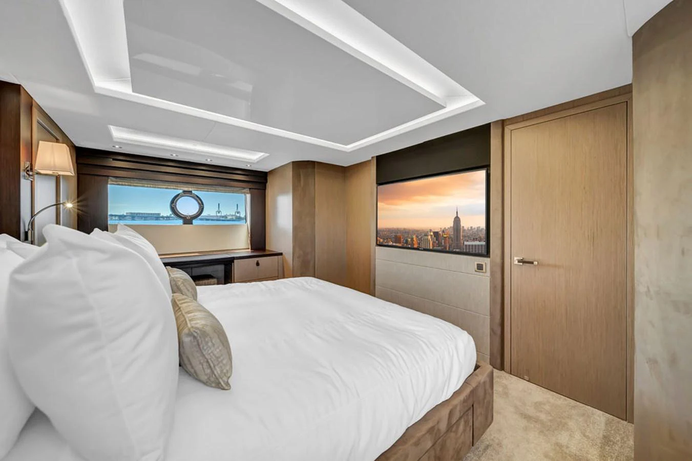 The stateroom features a luxurious bed with a scenic view through large windows. aboard SUNSEEKER Yacht for Sale
