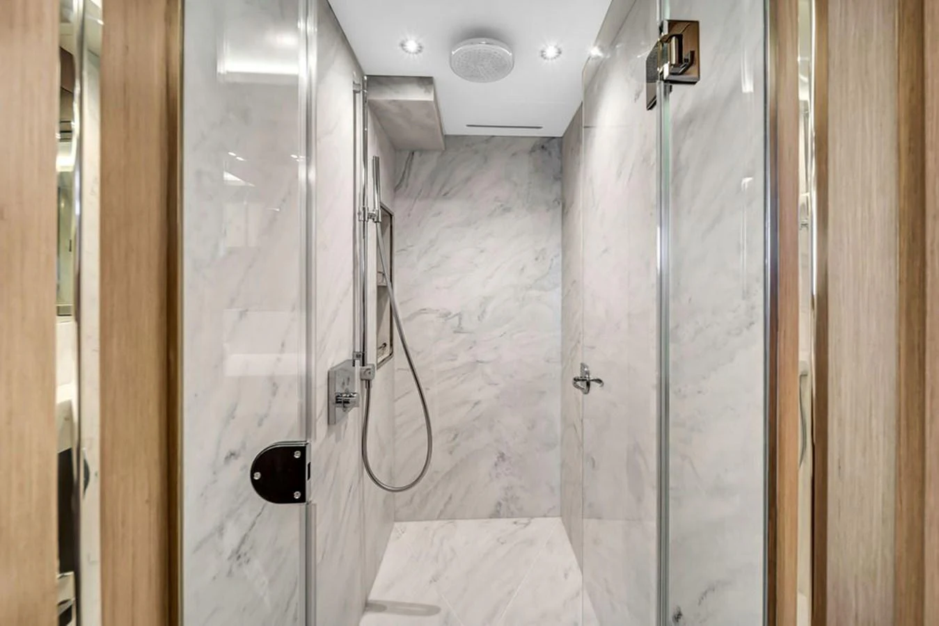 The yacht's bathroom features a luxurious marble shower with modern fixtures. aboard SUNSEEKER Yacht for Sale