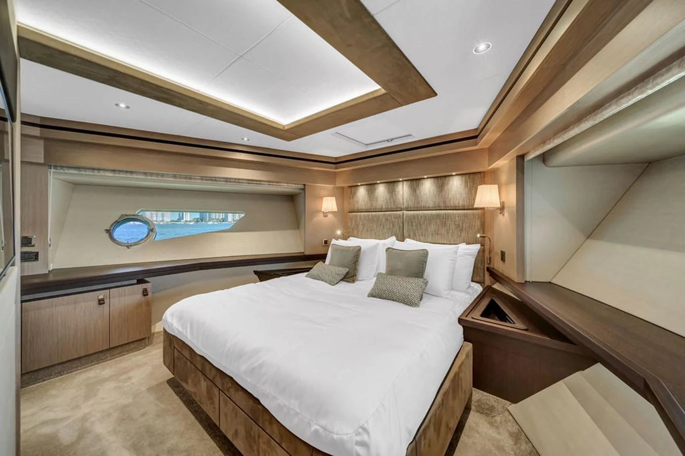 The master stateroom features a luxurious bed with elegant lighting and ample natural light from the window. aboard SUNSEEKER Yacht for Sale