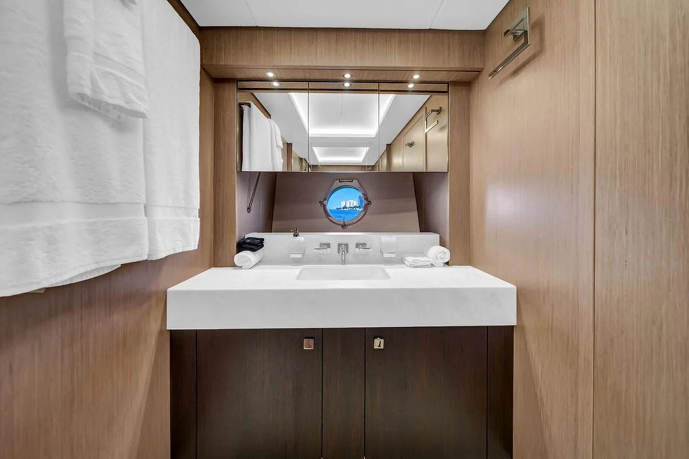 The yacht's bathroom features a sleek design with a modern sink and a porthole window. aboard SUNSEEKER Yacht for Sale