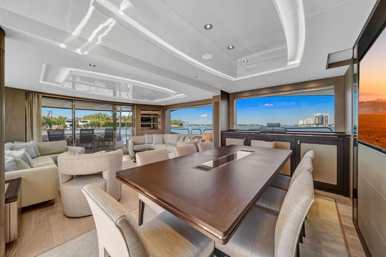 The spacious salon features elegant seating and a large dining table with panoramic views. aboard SUNSEEKER Yacht for Sale