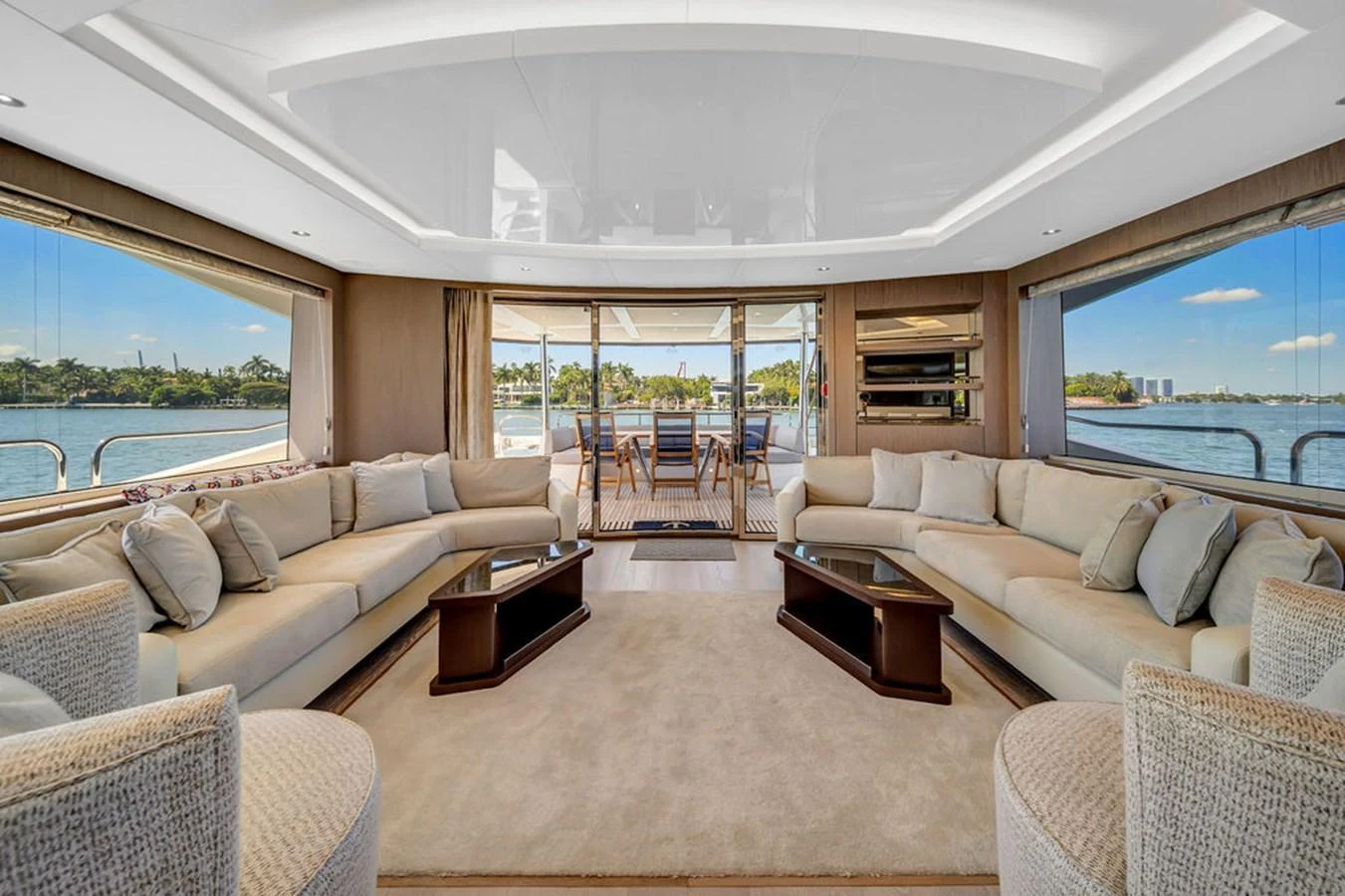 The spacious salon features elegant seating with panoramic views through large windows. aboard SUNSEEKER Yacht for Sale