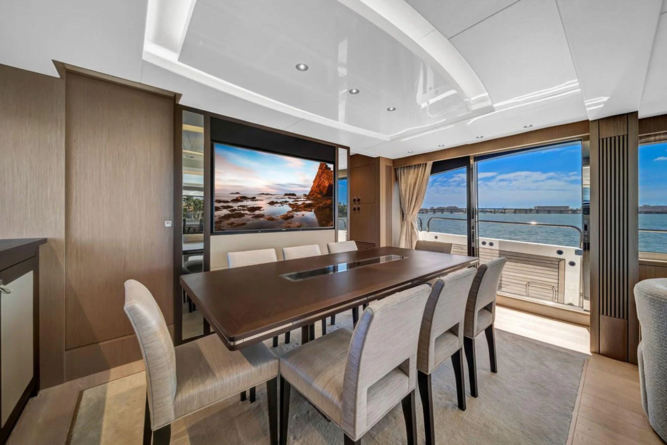The yacht's dining area features a large table with comfortable seating and expansive windows offering stunning views. aboard SUNSEEKER Yacht for Sale