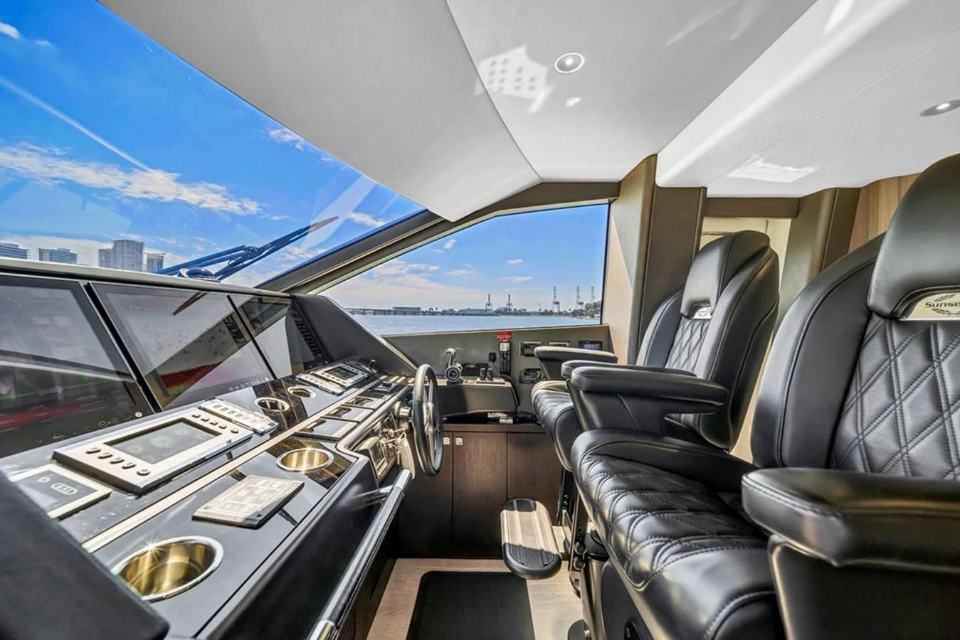 The helm station features luxurious leather seating and state-of-the-art navigation equipment with panoramic views. aboard SUNSEEKER Yacht for Sale