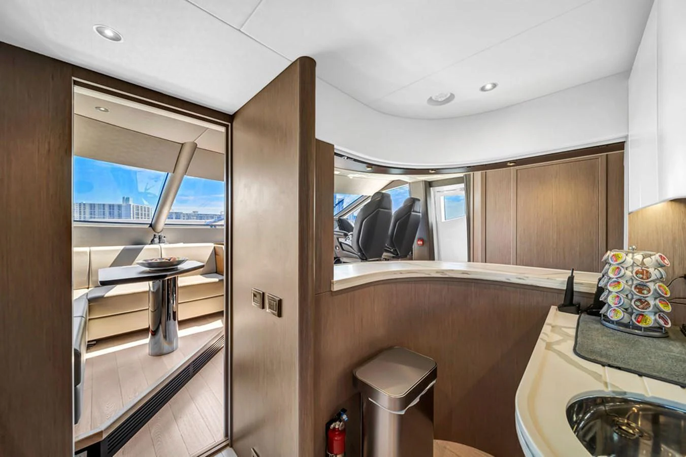 The yacht's galley features modern cabinetry and a cozy dining area with a view. aboard SUNSEEKER Yacht for Sale