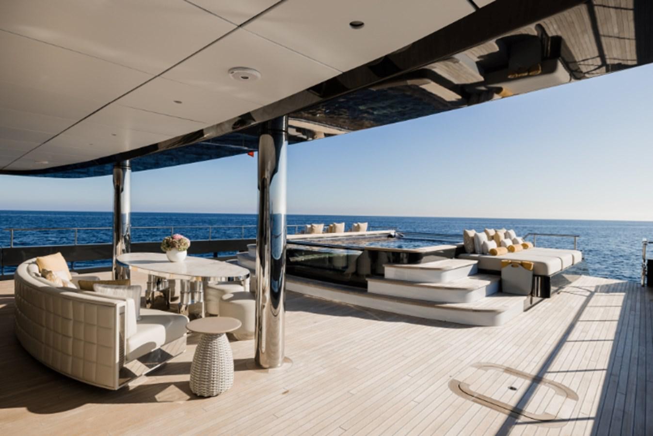 a room with a view of the ocean and a large patio aboard LOON Yacht for Sale