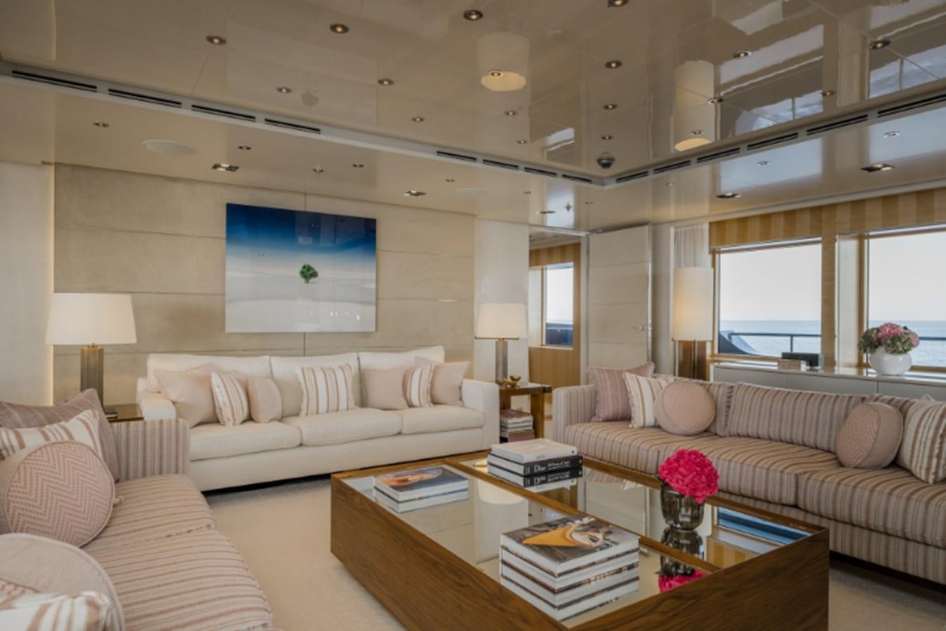 a living room with a couch and a coffee table aboard LOON Yacht for Sale