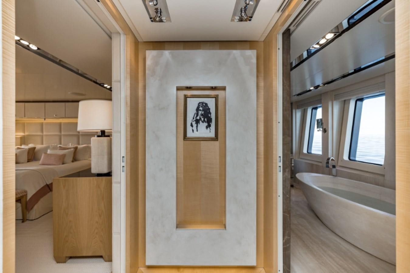 a room with a bed and a mirror aboard LOON Yacht for Sale