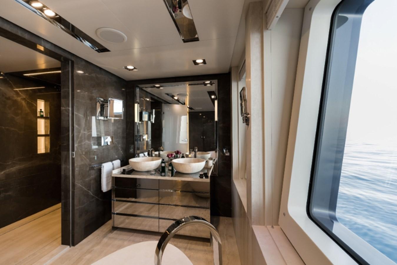 a bathroom with sinks and mirrors aboard LOON Yacht for Sale
