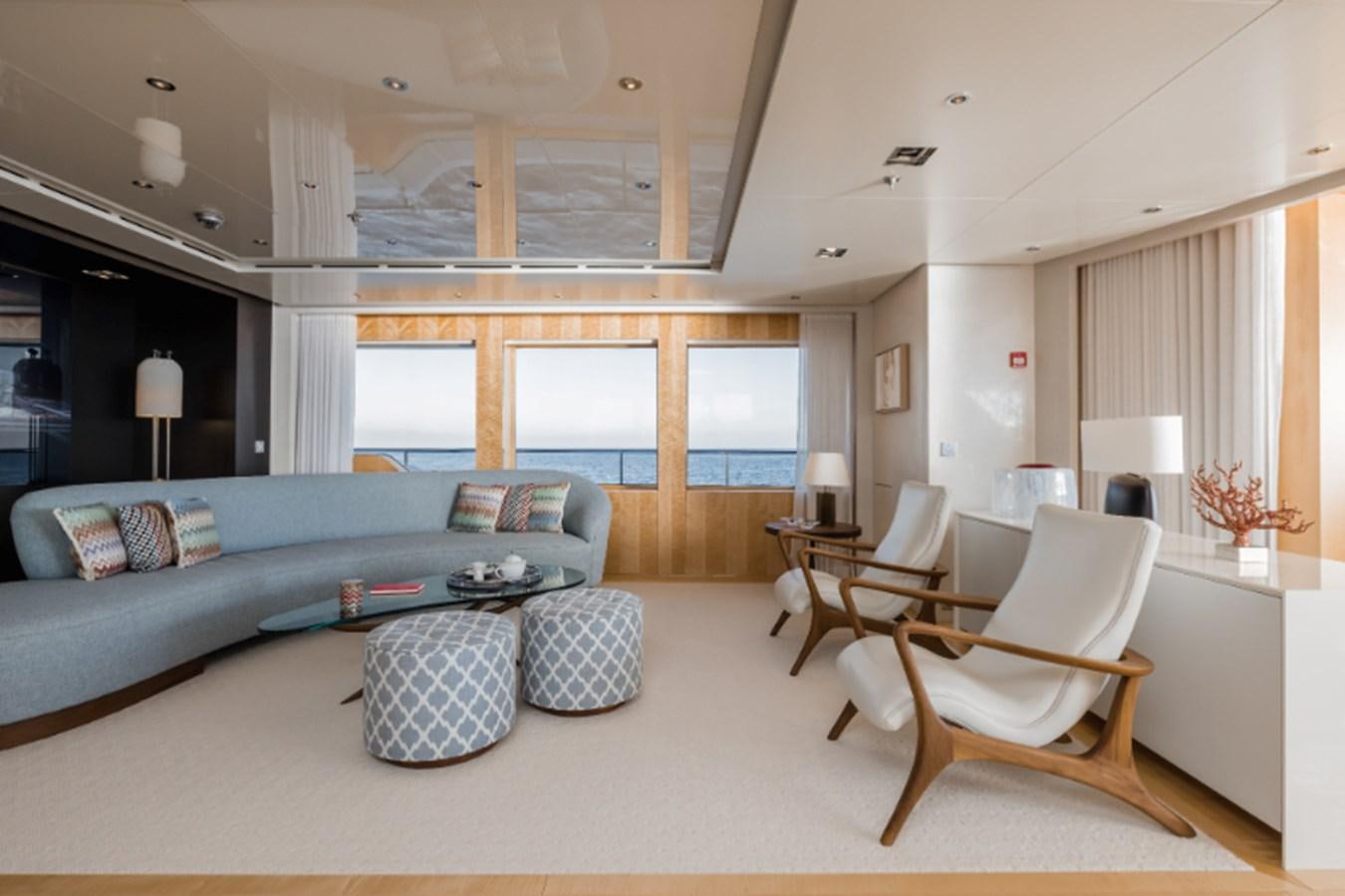 a living room with a couch and a table aboard LOON Yacht for Sale