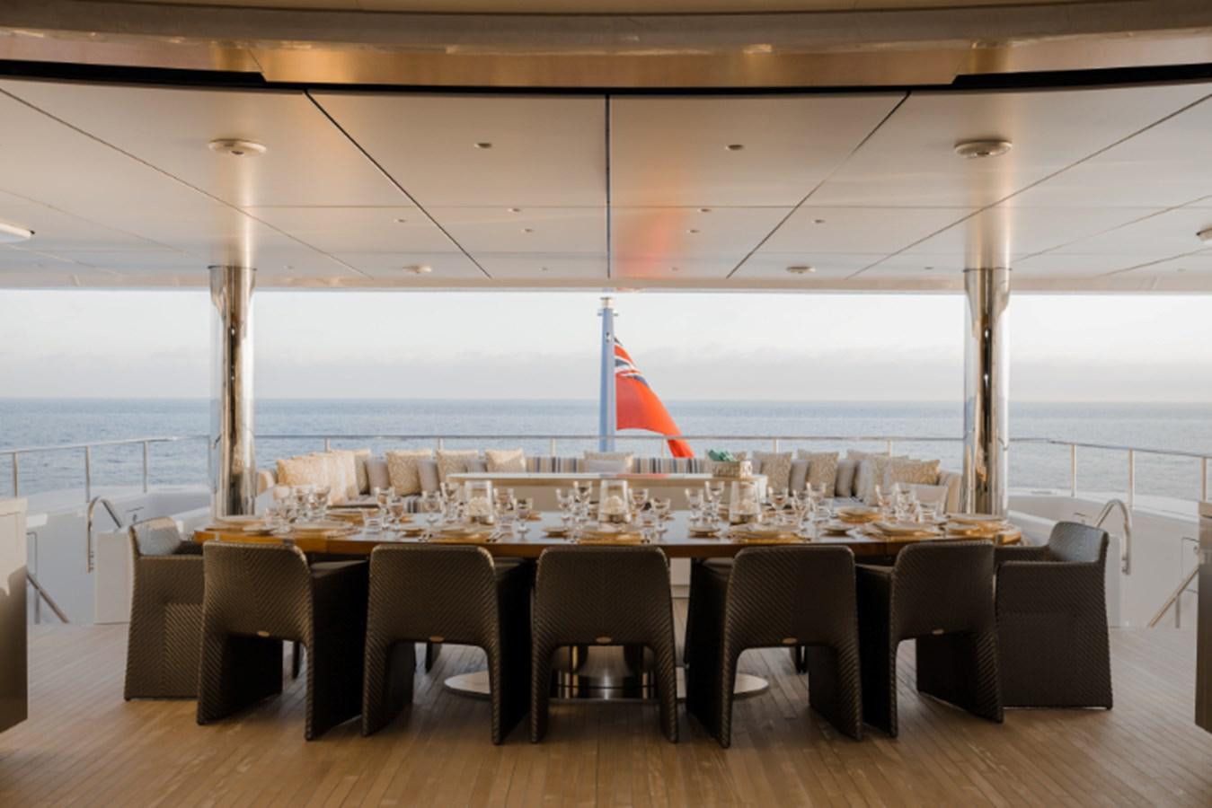 a room with tables and chairs aboard LOON Yacht for Sale