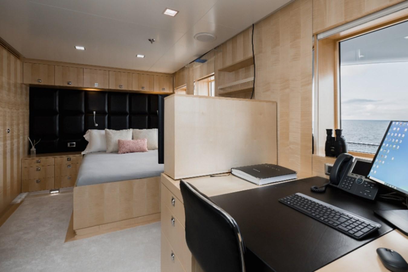 a room with a bed and a laptop aboard LOON Yacht for Sale