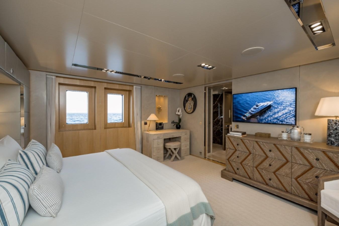 a large bedroom with a large screen aboard LOON Yacht for Sale