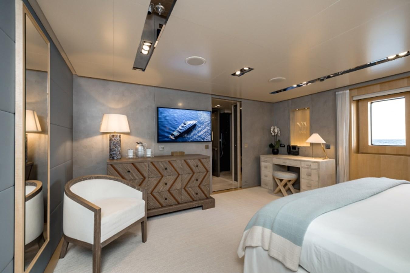 a large bedroom with a large tv aboard LOON Yacht for Sale