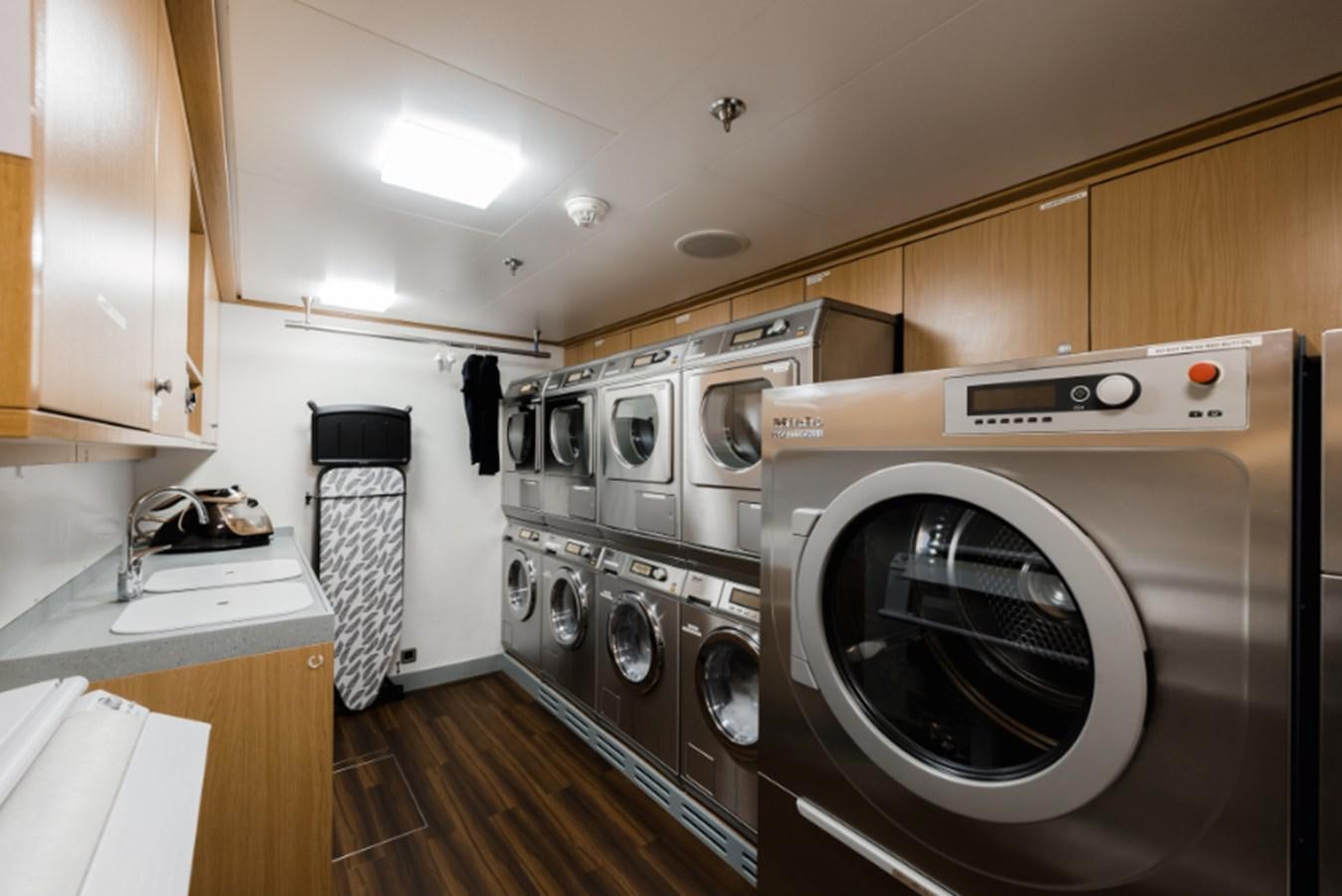 a kitchen with a washing machine and dryer aboard LOON Yacht for Sale