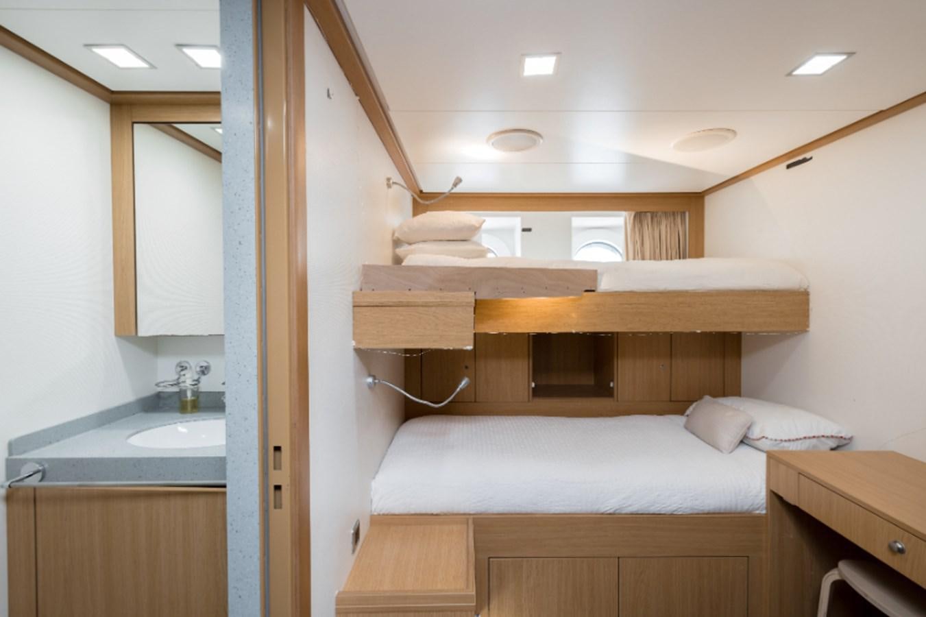 a room with a bed and a sink aboard LOON Yacht for Sale
