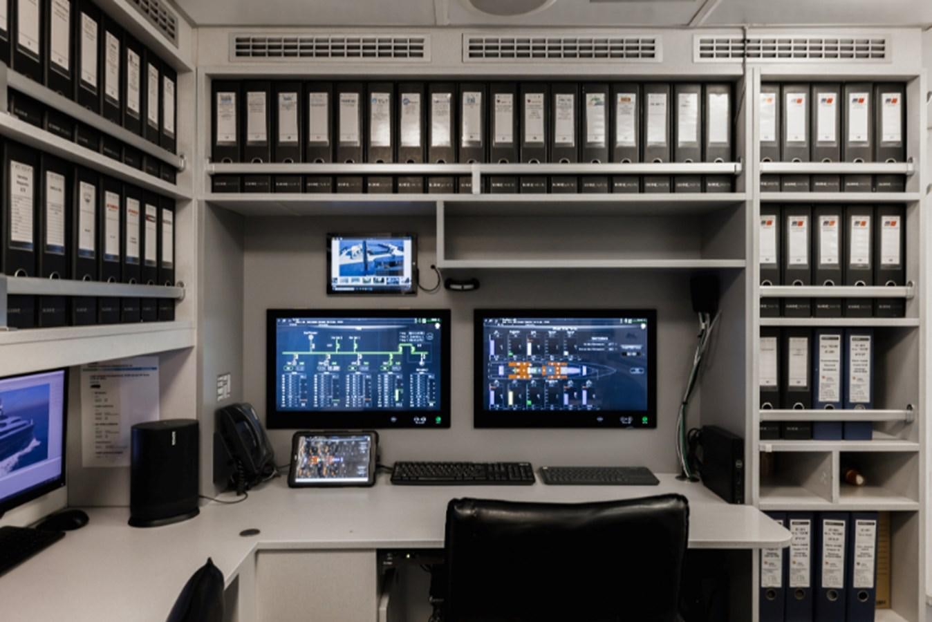 a room with computers and monitors aboard LOON Yacht for Sale