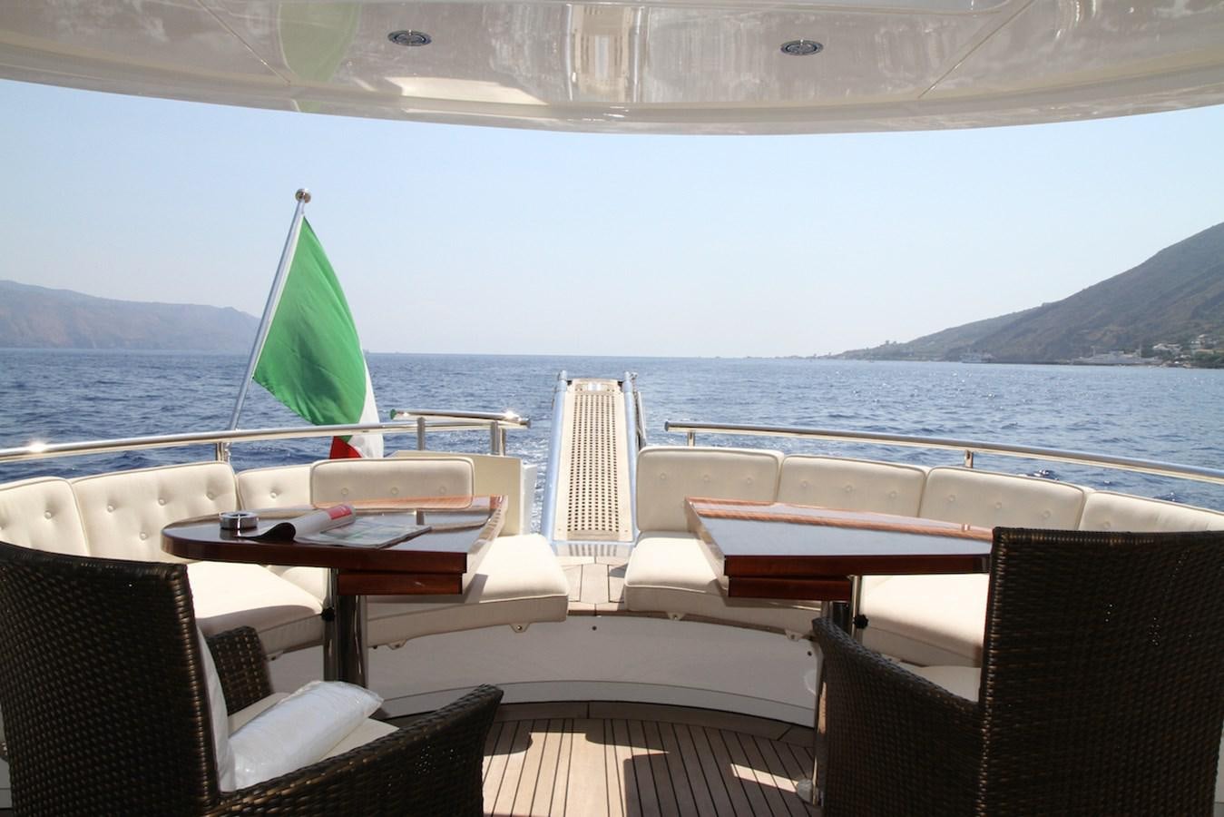 a deck with chairs and tables on it by a body of water aboard LADY ROSE Yacht for Sale