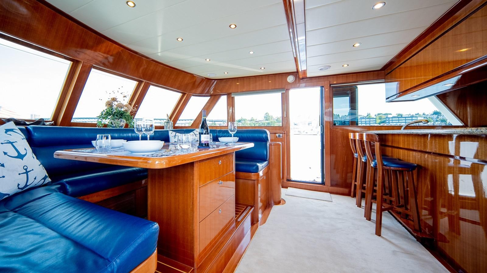 a room with a table and chairs aboard SEA CZAR Yacht for Sale