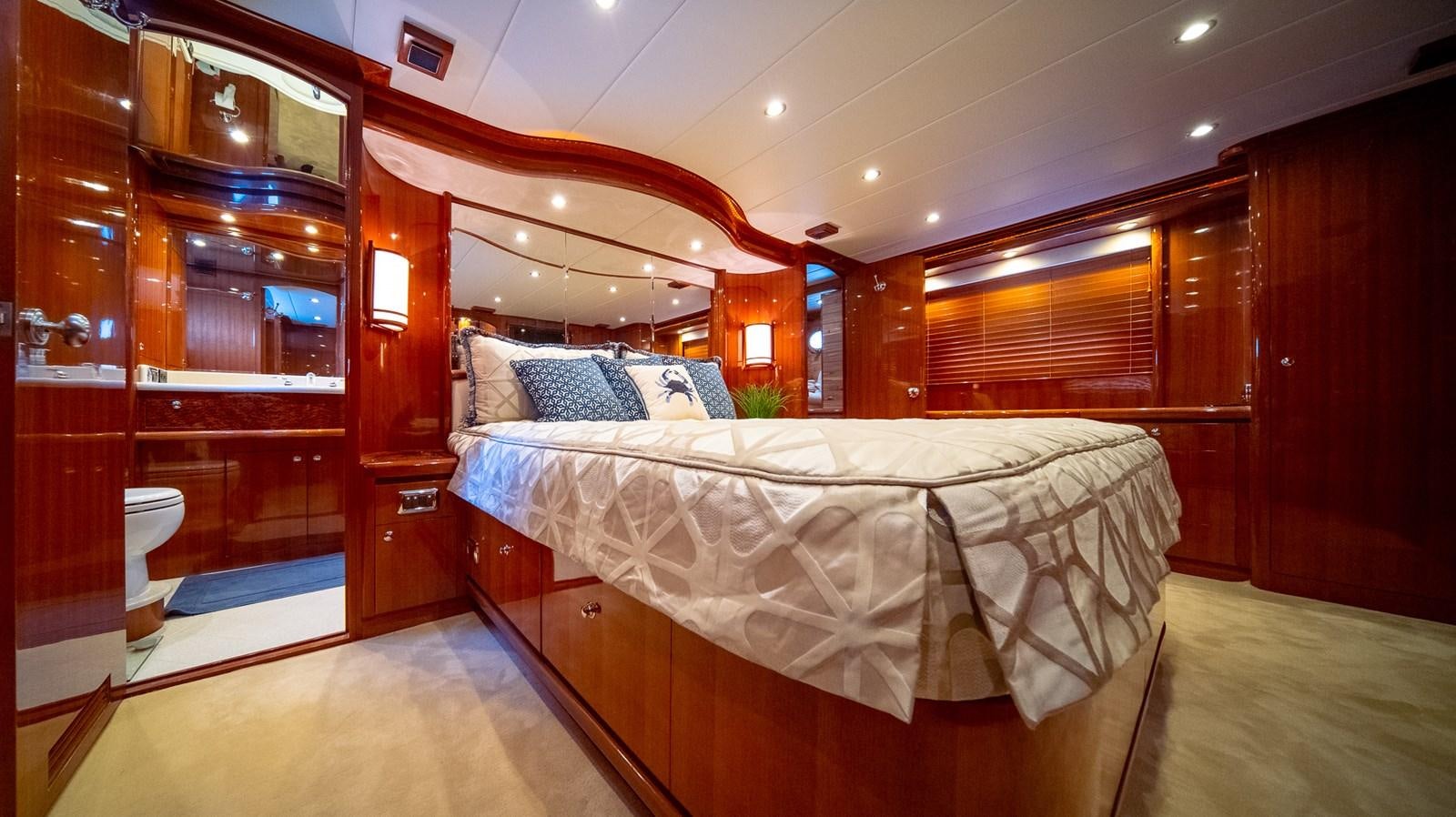 a room with a bed and a mirror aboard SEA CZAR Yacht for Sale