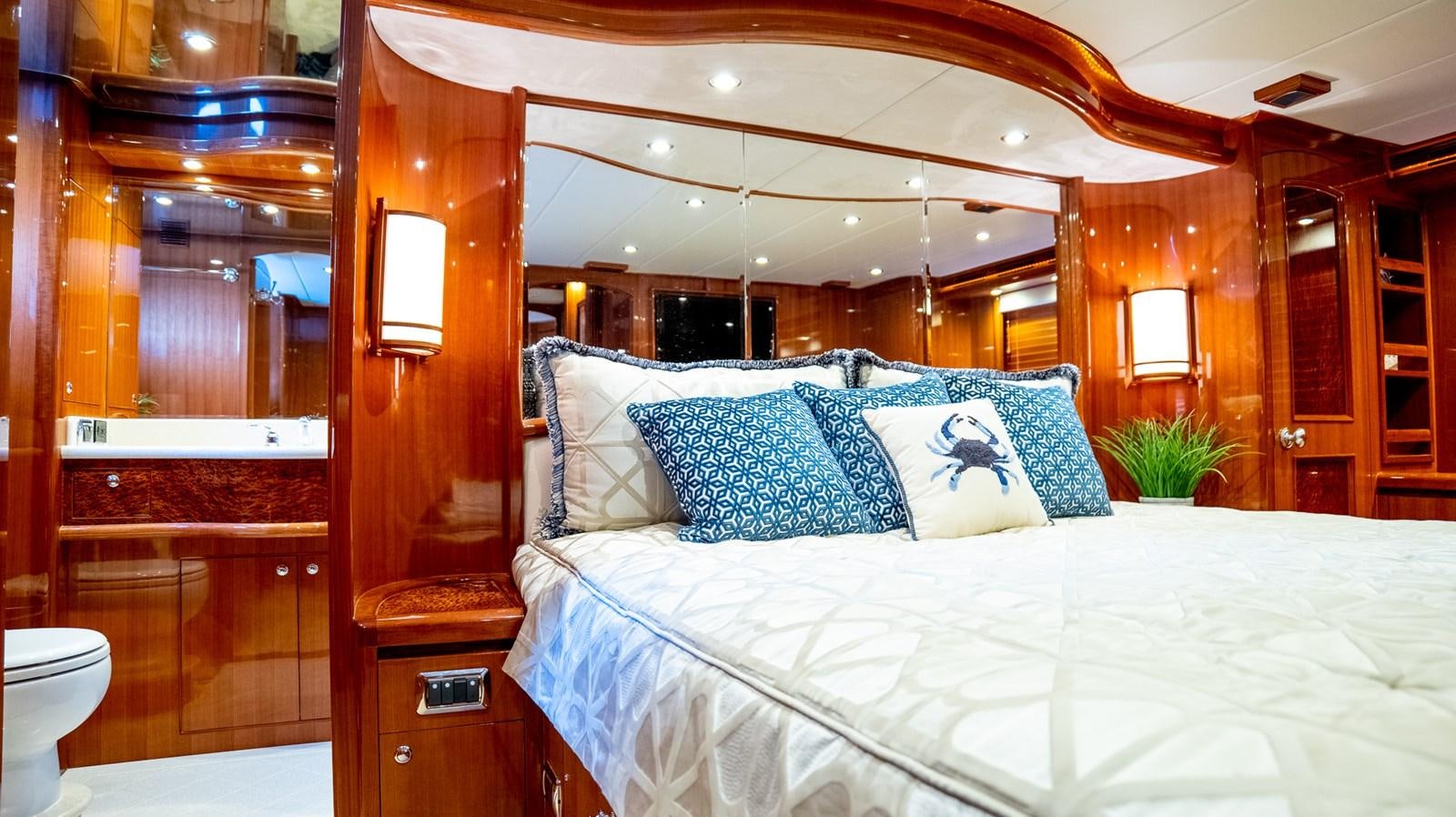 a bed with a white comforter aboard SEA CZAR Yacht for Sale