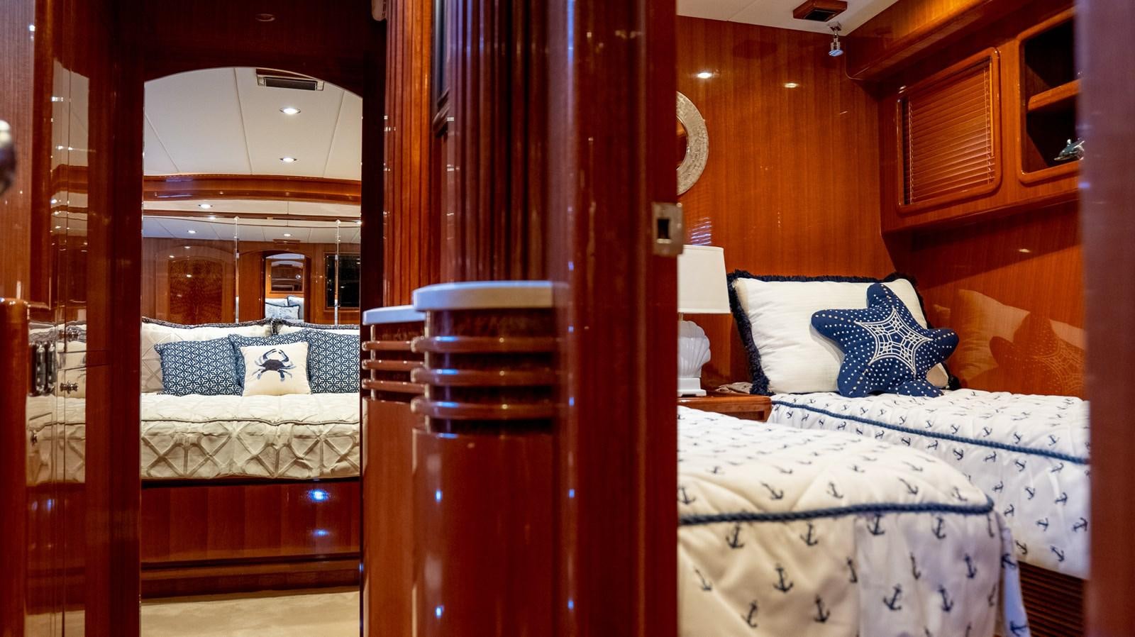 a room with a bed and a mirror aboard SEA CZAR Yacht for Sale