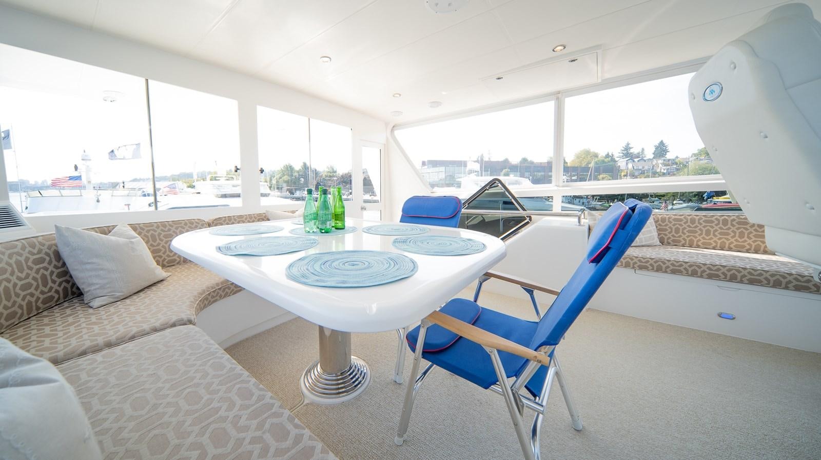 a table and chairs in a room aboard SEA CZAR Yacht for Sale