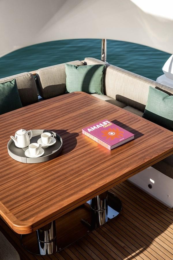 a table with a tray of food and a book on it aboard 66 MAGELLANO Yacht for Sale