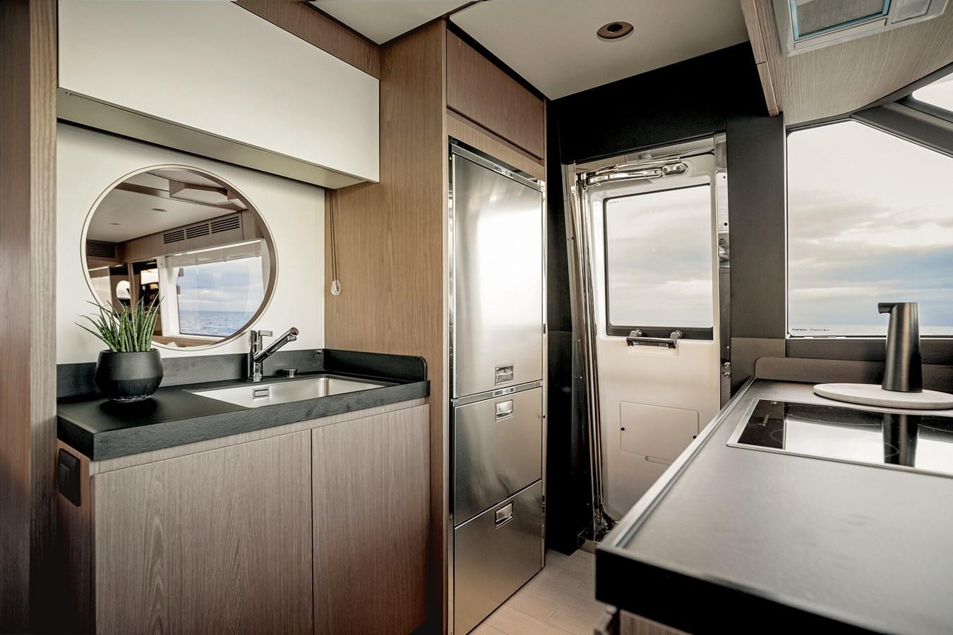 a kitchen with a large mirror aboard 66 MAGELLANO Yacht for Sale