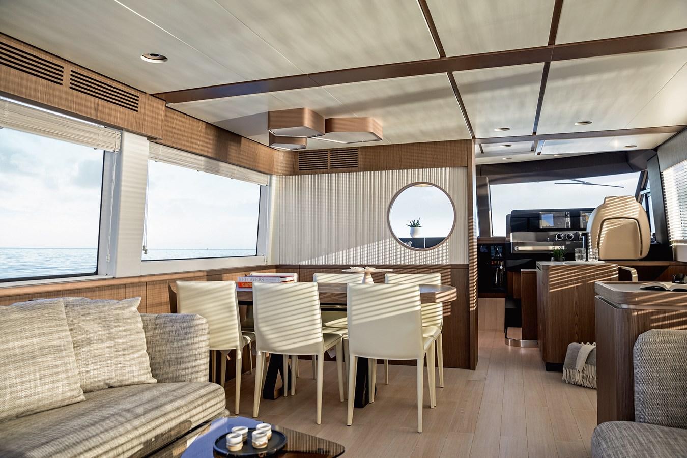 a room with a table chairs and a couch aboard 66 MAGELLANO Yacht for Sale