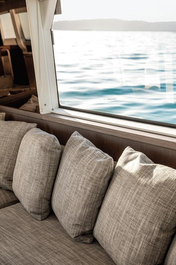 a couch and a window aboard 66 MAGELLANO Yacht for Sale