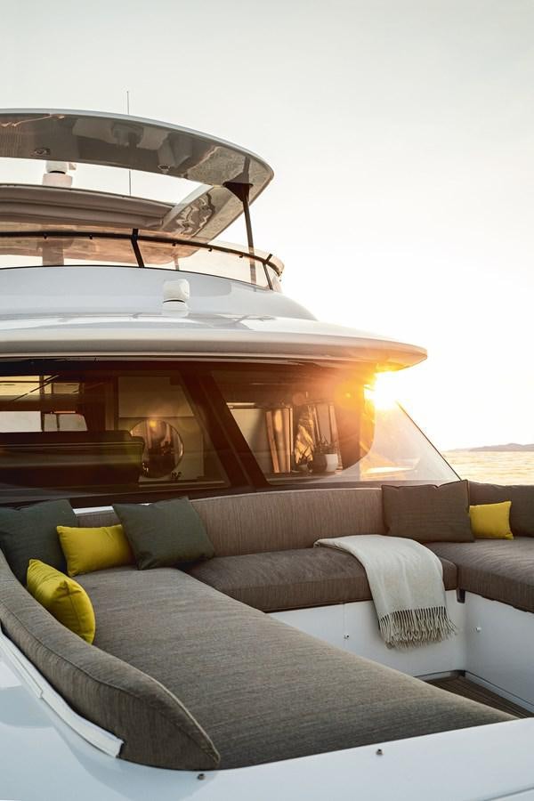 a room with a couch and a table with chairs aboard 66 MAGELLANO Yacht for Sale