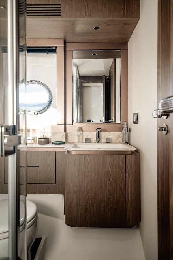 a bathroom with a sink and a mirror aboard 66 MAGELLANO Yacht for Sale