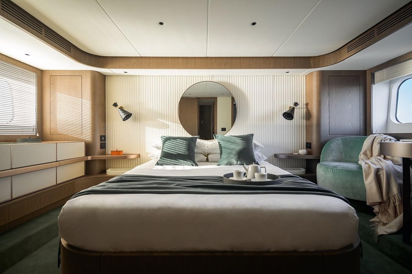 a bed with a black bed spread aboard 66 MAGELLANO Yacht for Sale