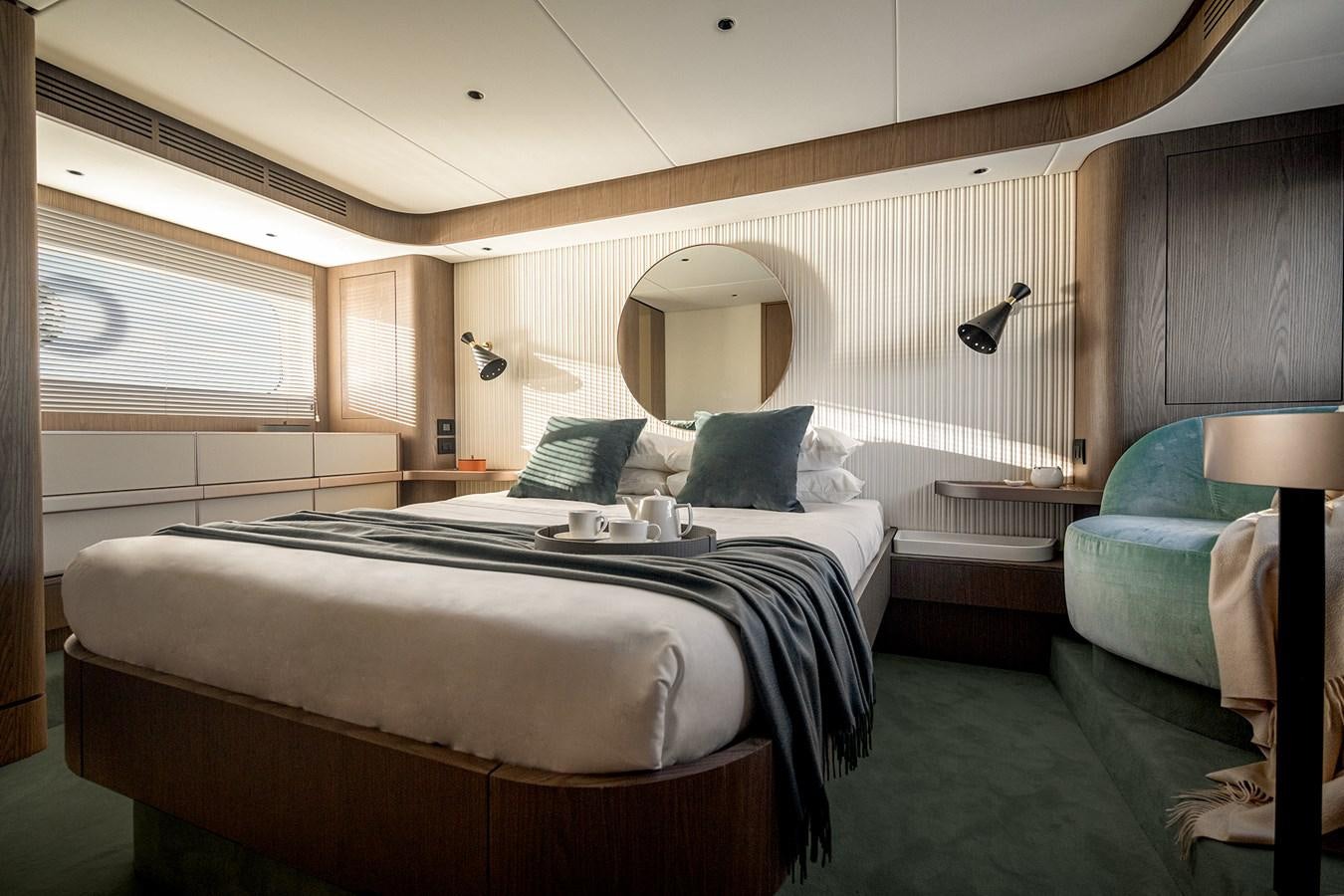 a room with a bed and a mirror aboard 66 MAGELLANO Yacht for Sale