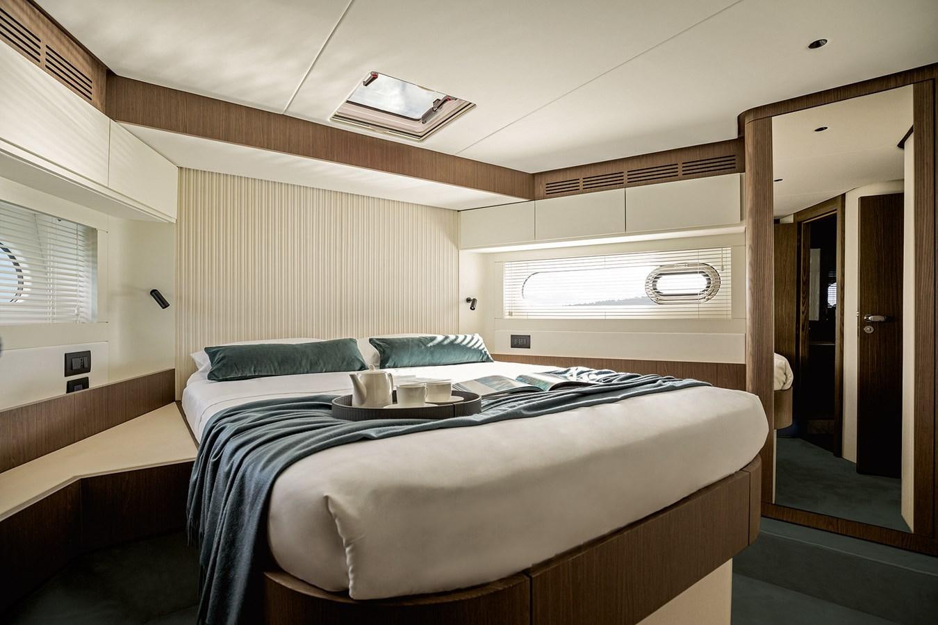 a room with a bed and a mirror aboard 66 MAGELLANO Yacht for Sale