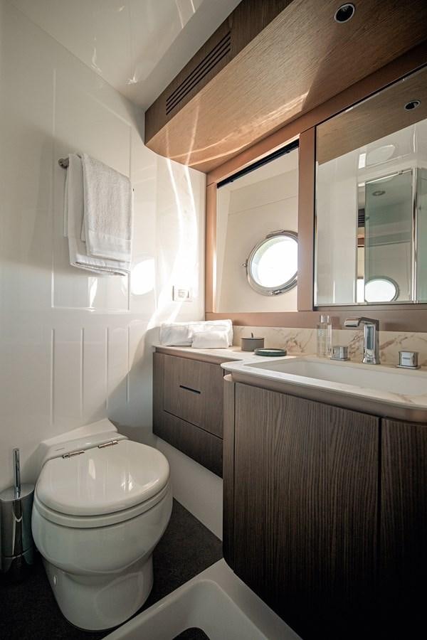 a bathroom with a toilet and a sink aboard 66 MAGELLANO Yacht for Sale