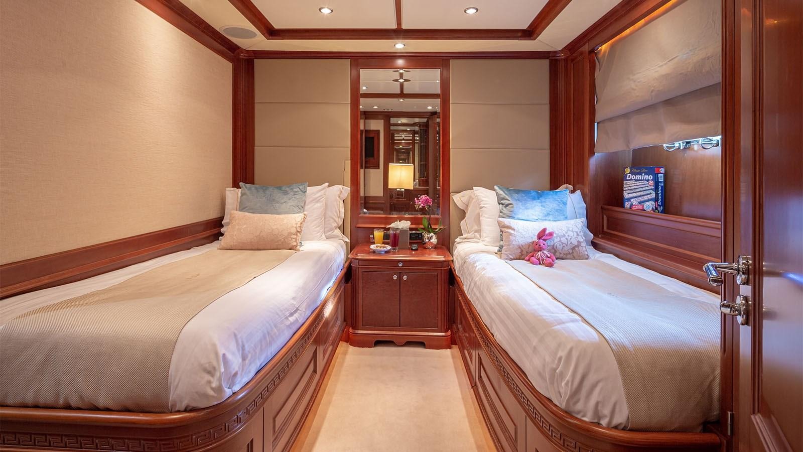 a hotel room with two beds aboard RIVA I Yacht for Sale